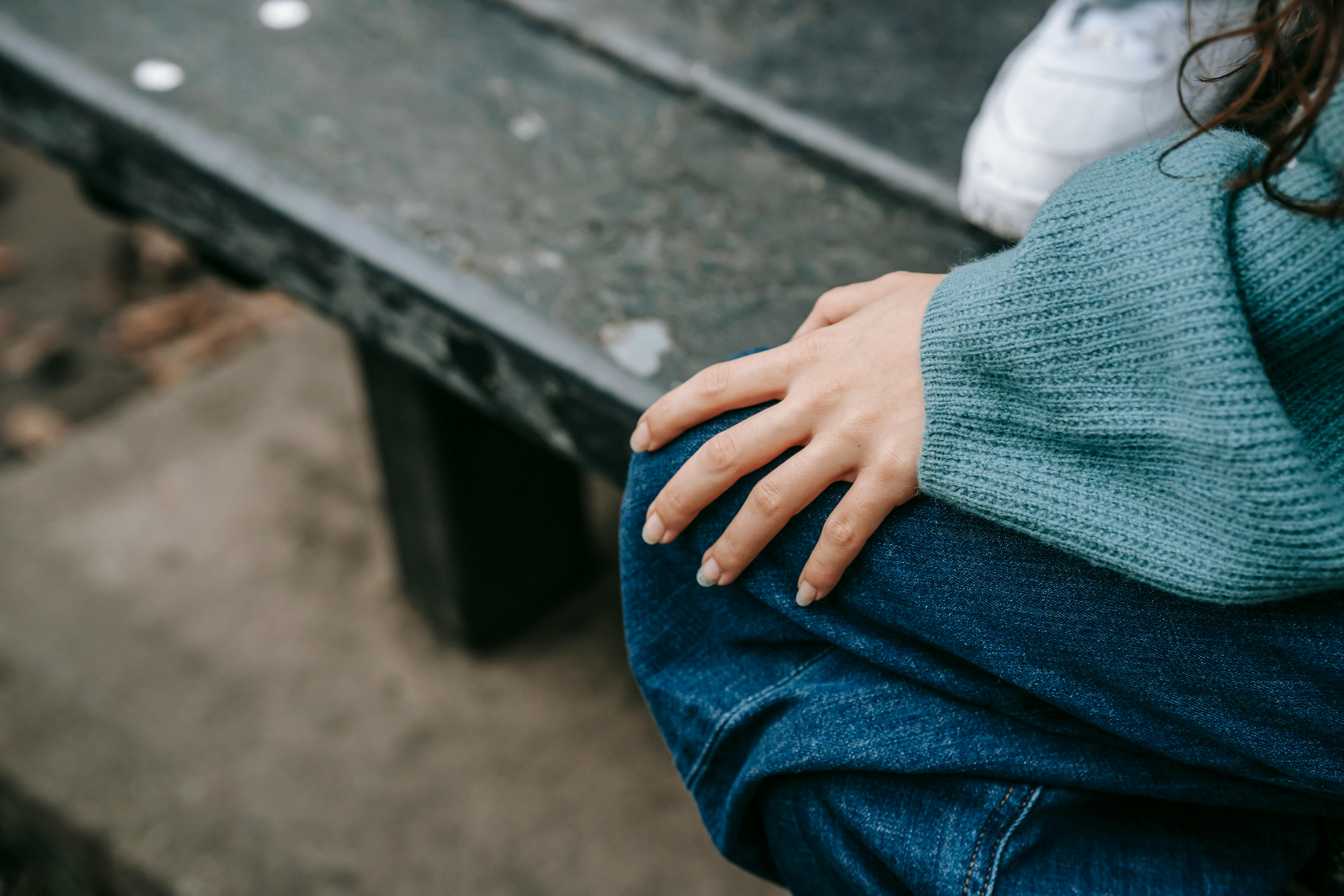 Person sitting beside a bench after the funeral